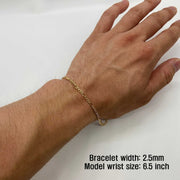 Close-up of a model wearing a 2.5mm 10k gold pave Figaro link bracelet on wrist.