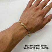 Close-up of a model wearing a 6.5mm 10k gold pave Figaro link bracelet on wrist.