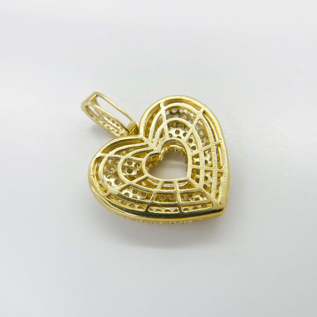 Back view of 10k gold puffy heart pendant showing filigree lattice structure.