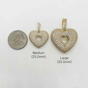 Size chart comparing Medium and Large gold CZ heart pendants with a US quarter.