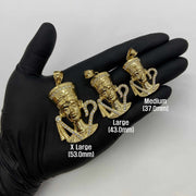 Size comparison of 10k yellow gold Queen Nefertiti CZ pendants displayed on a gloved hand.