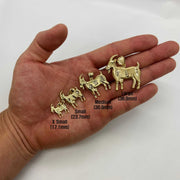 Five sizes of 10k yellow gold satin goat pendants resting on an open palm.