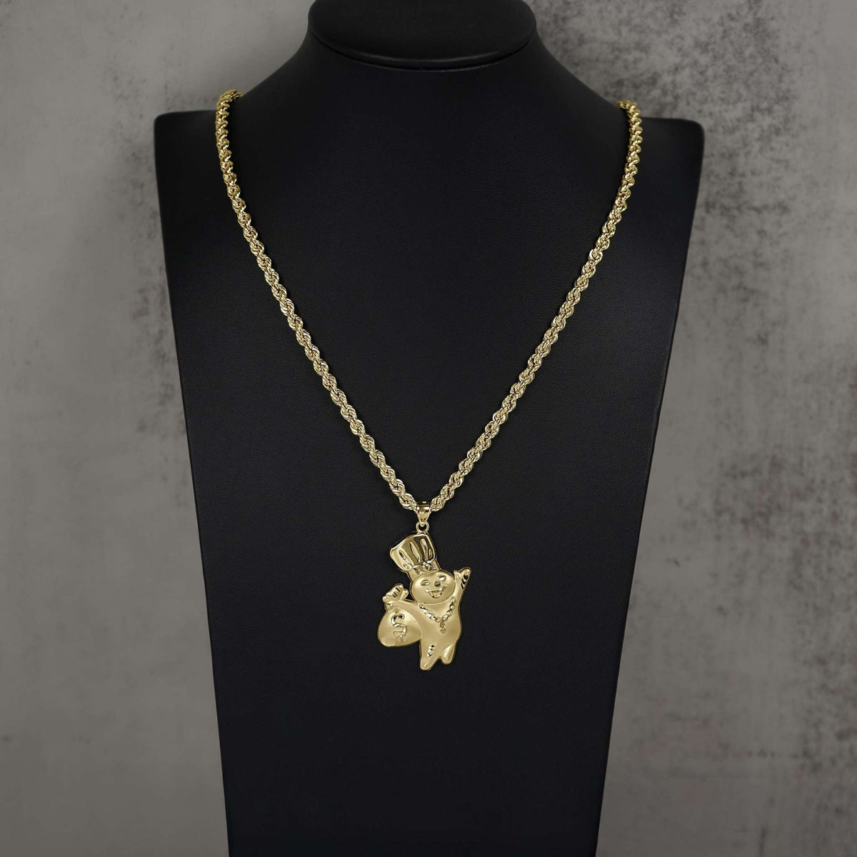 10k gold Pillsbury Doughboy pendant necklace displayed on a black jewelry mannequin bust.