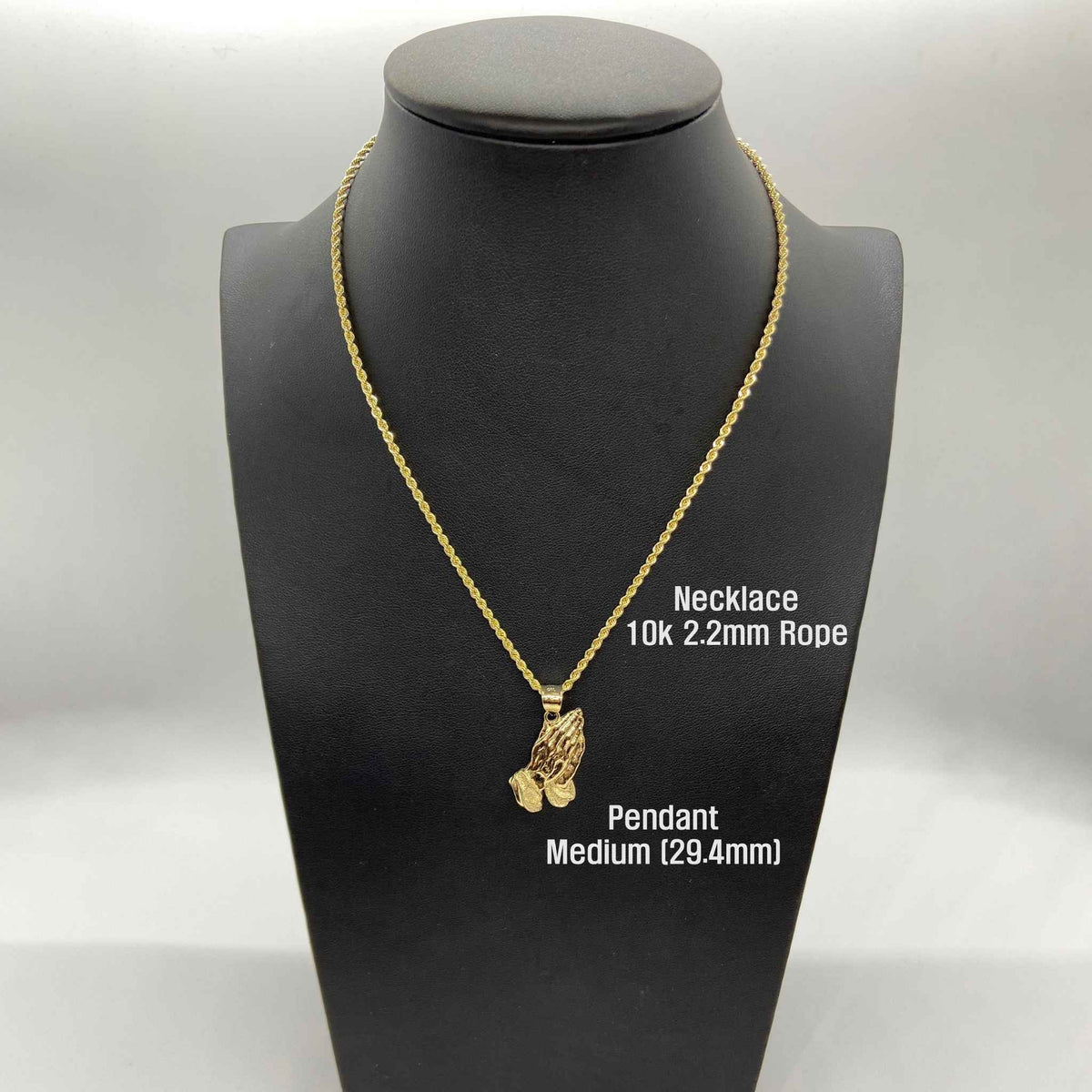 Medium 29.4mm 10k gold praying hands pendant on a 2.2mm rope chain bust display.
