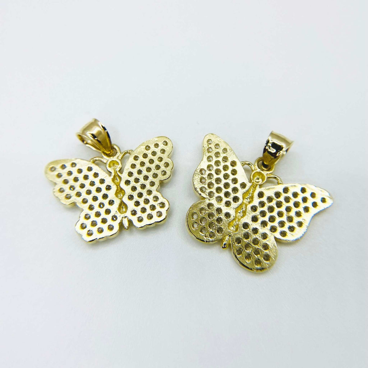 Back view showing two 10k gold butterfly pendants with textured mesh detailing.