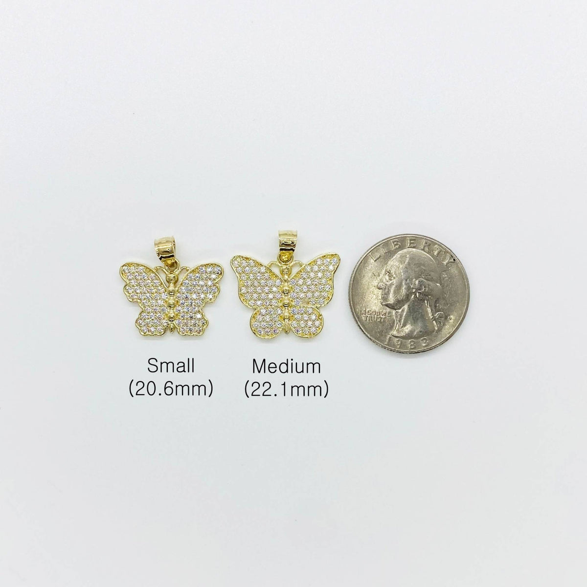 Small and medium gold butterfly CZ pendants displayed next to a US quarter for scale.