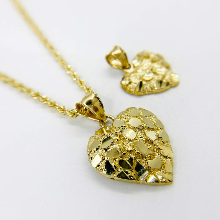 Two 10k solid gold nugget heart charm pendants with rope chain background.
