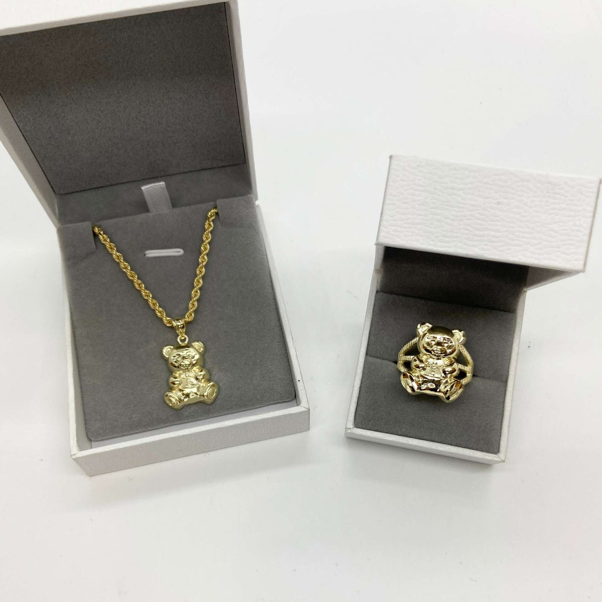 10k Gold teddy bear pendant necklace and ring in open jewelry boxes.