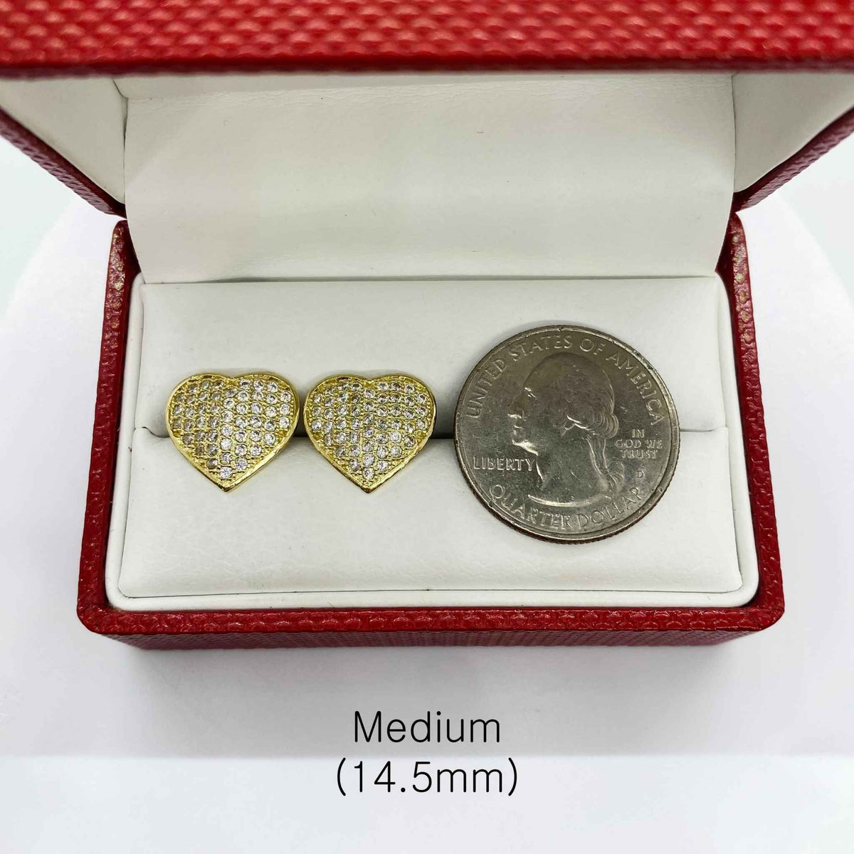 Size comparison of 14.5mm heart-shaped gold CZ earrings and a U.S. quarter coin.