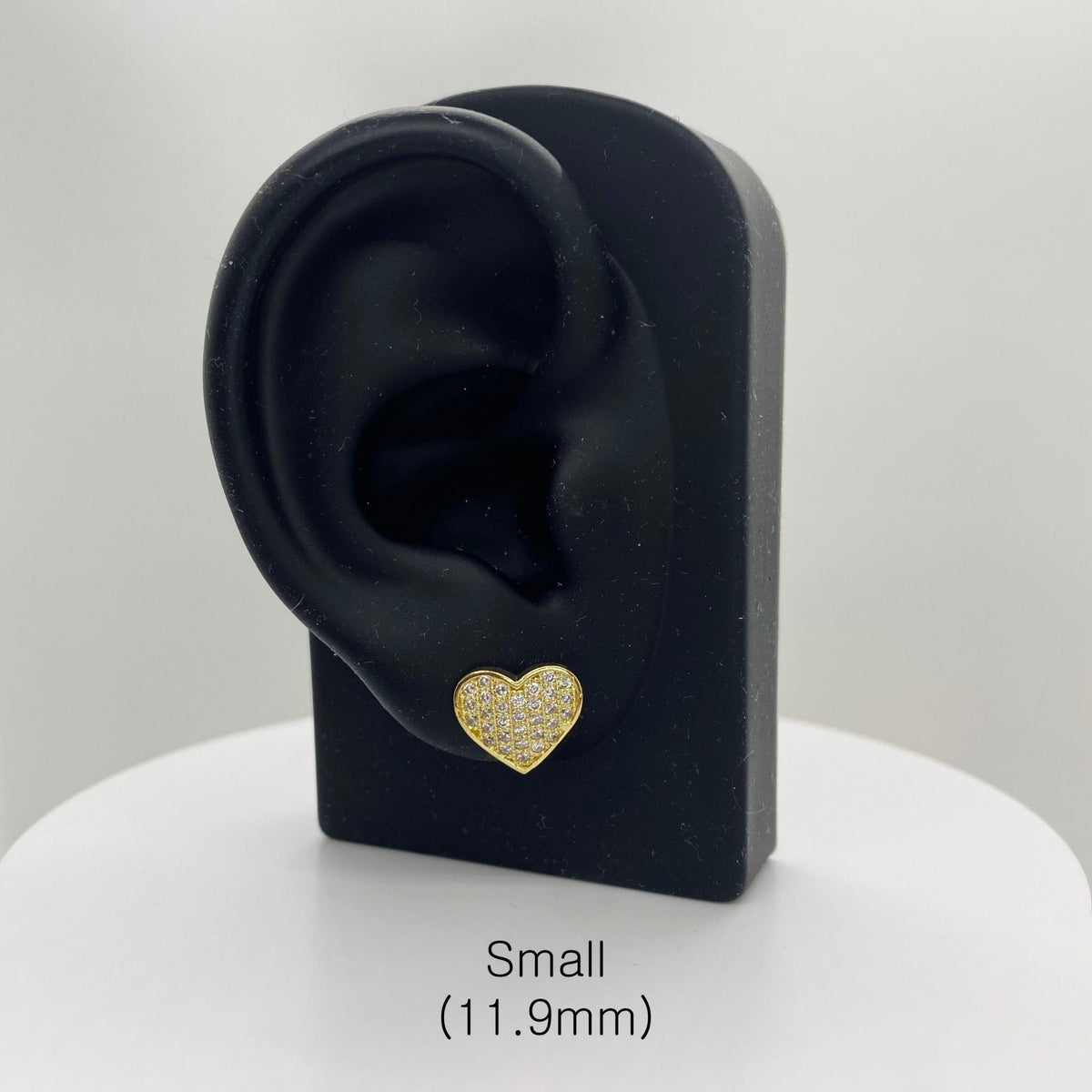 Small 11.9mm gold heart CZ stud earring displayed on a black ear-shaped jewelry stand.