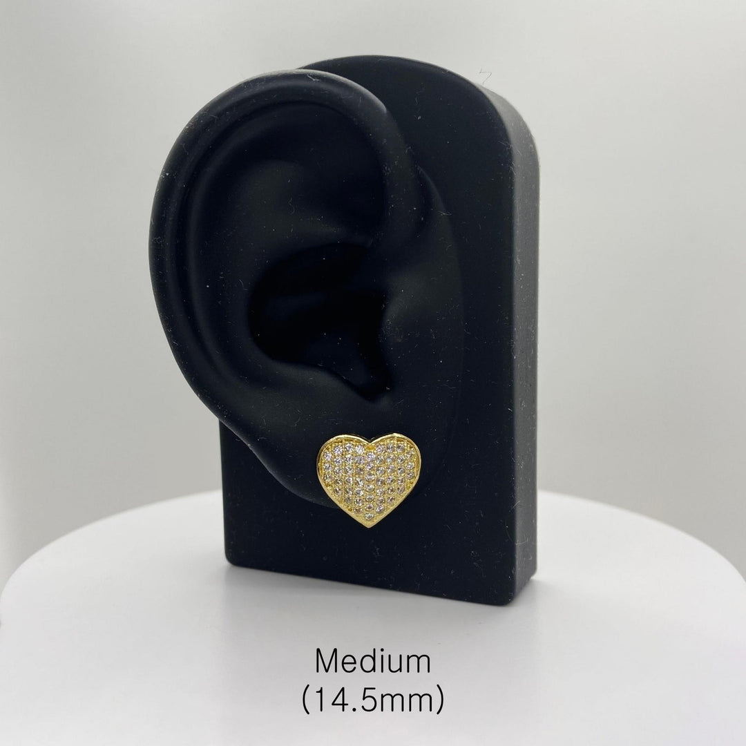 Medium 14.5mm gold heart CZ stud earring on a black ear-shaped jewelry stand.