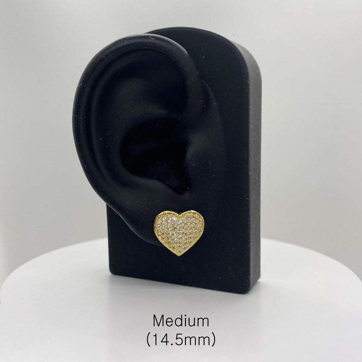 Medium 14.5mm gold heart CZ stud earring on a black ear-shaped jewelry stand.