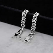 Two 10k white gold Miami Cuban link chains displayed side by side on dark velvet.