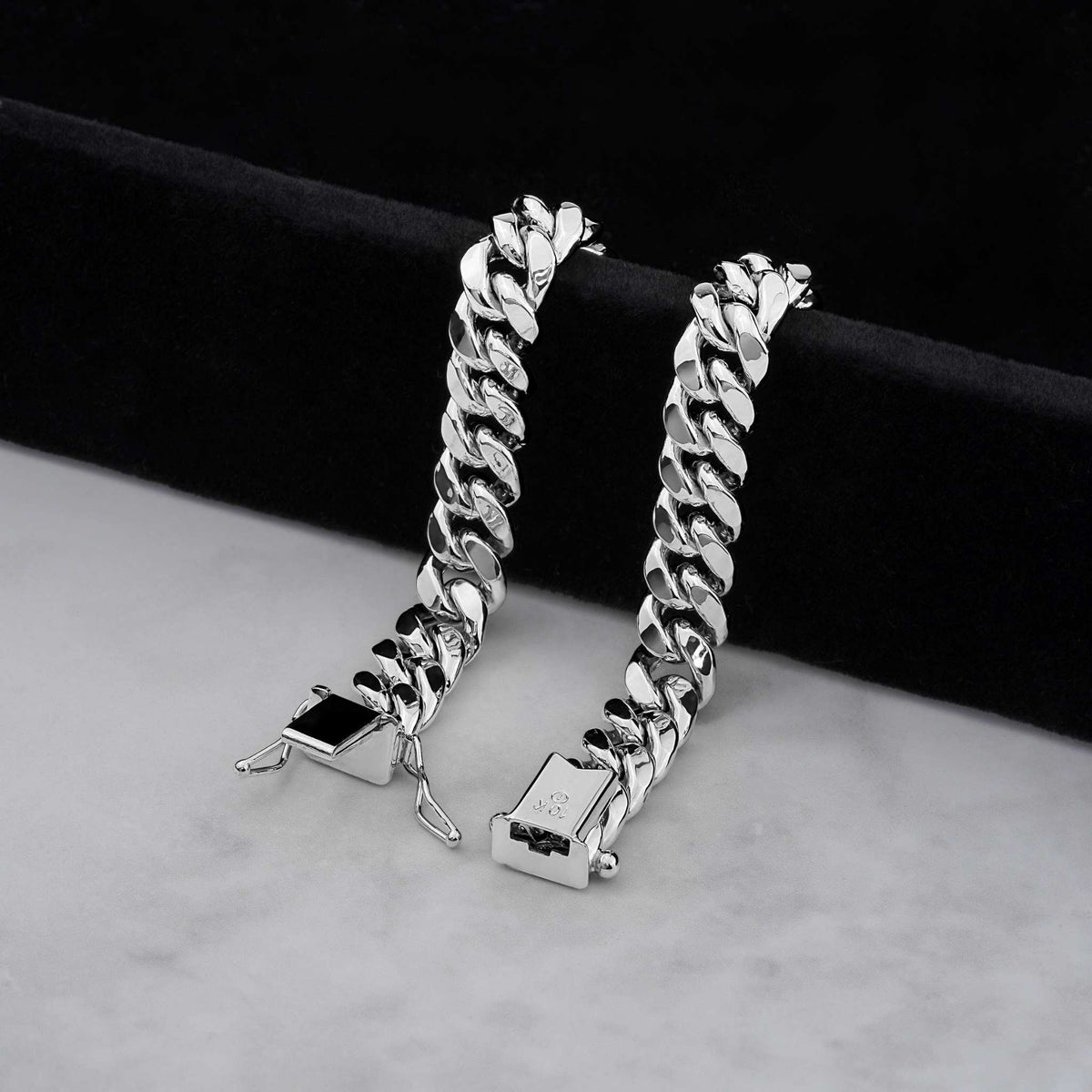Two 10k white gold Miami Cuban link chains displayed side by side on dark velvet.
