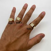 Hand wearing three 10k - 14k Gold Oath Square rings with different style on a white background