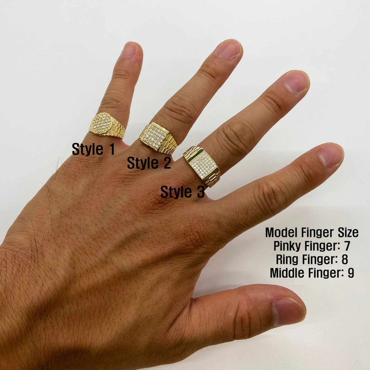 Hand wearing three 10k - 14k Gold Rollie rings with size labels on a white background
