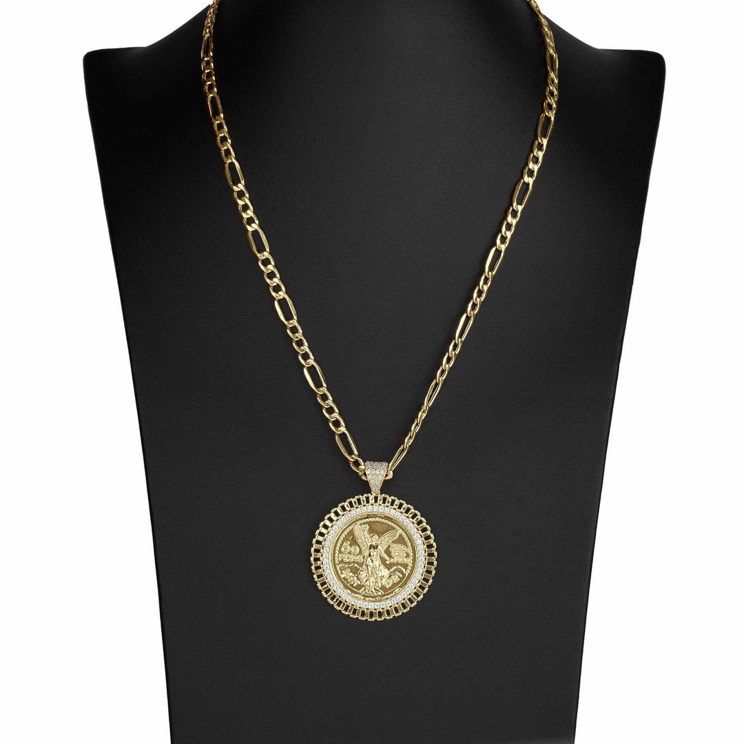 Gold Figaro chain necklace with a circular coin pendant displayed on a black jewelry bust.