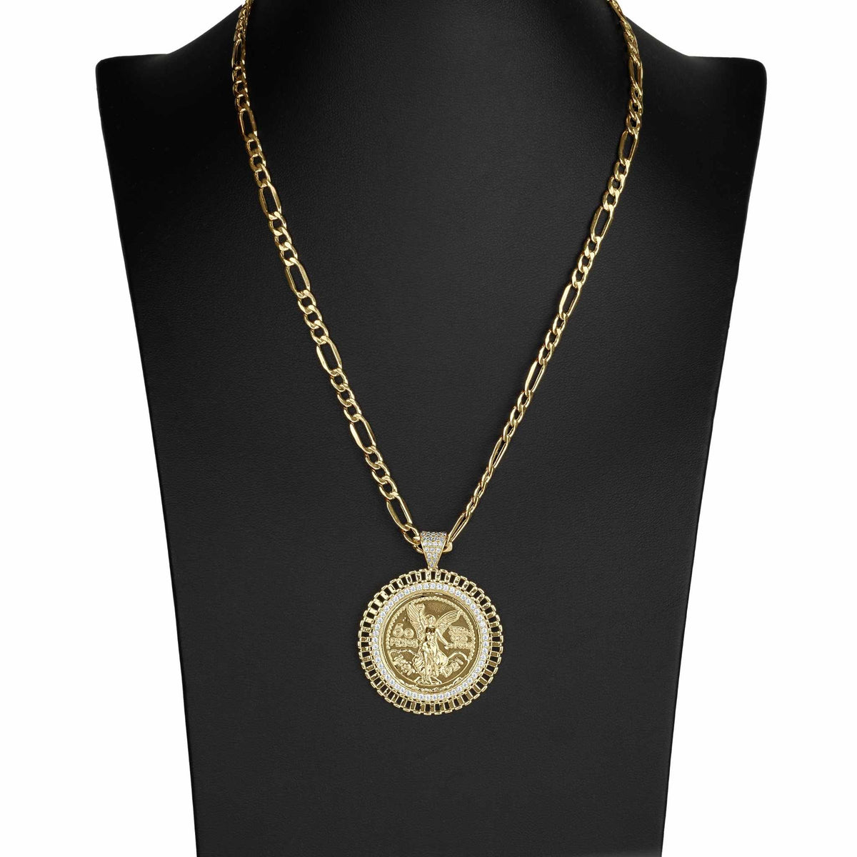 Gold Figaro chain necklace with a circular coin pendant displayed on a black jewelry bust.