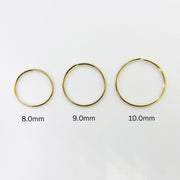 Three 14k gold nose hoops in 8.0mm, 9.0mm, and 10.0mm size comparison.