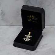 14k two-tone gold crucifix anchor pendant necklace presented inside an open black jewelry box.