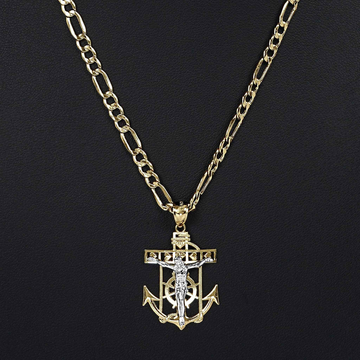 Front view of a 14k two-tone gold crucifix anchor pendant necklace on Figaro chain.