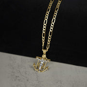 14k gold crucifix anchor pendant necklace displayed on a split black and gray background.