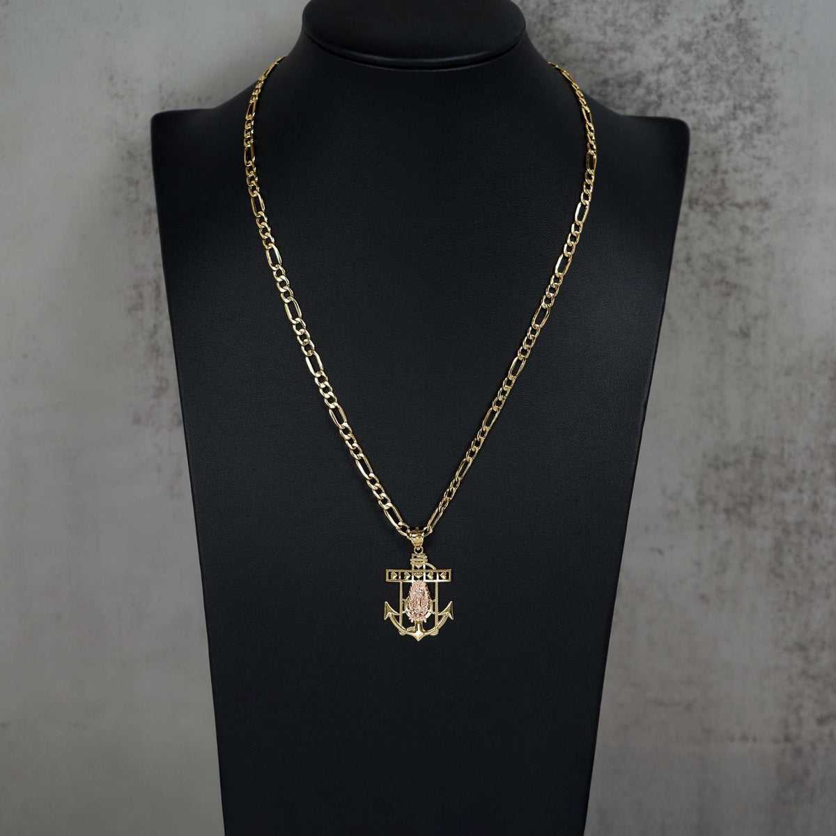 14k gold Lady Guadalupe anchor pendant necklace featured on a black jewelry mannequin display