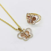Detailed view of 14k tri-color gold butterfly pendant on rope chain with matching ring.