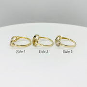 Three 14k gold rings with infinity design side view labeled Style 1, Style 2, and Style 3 