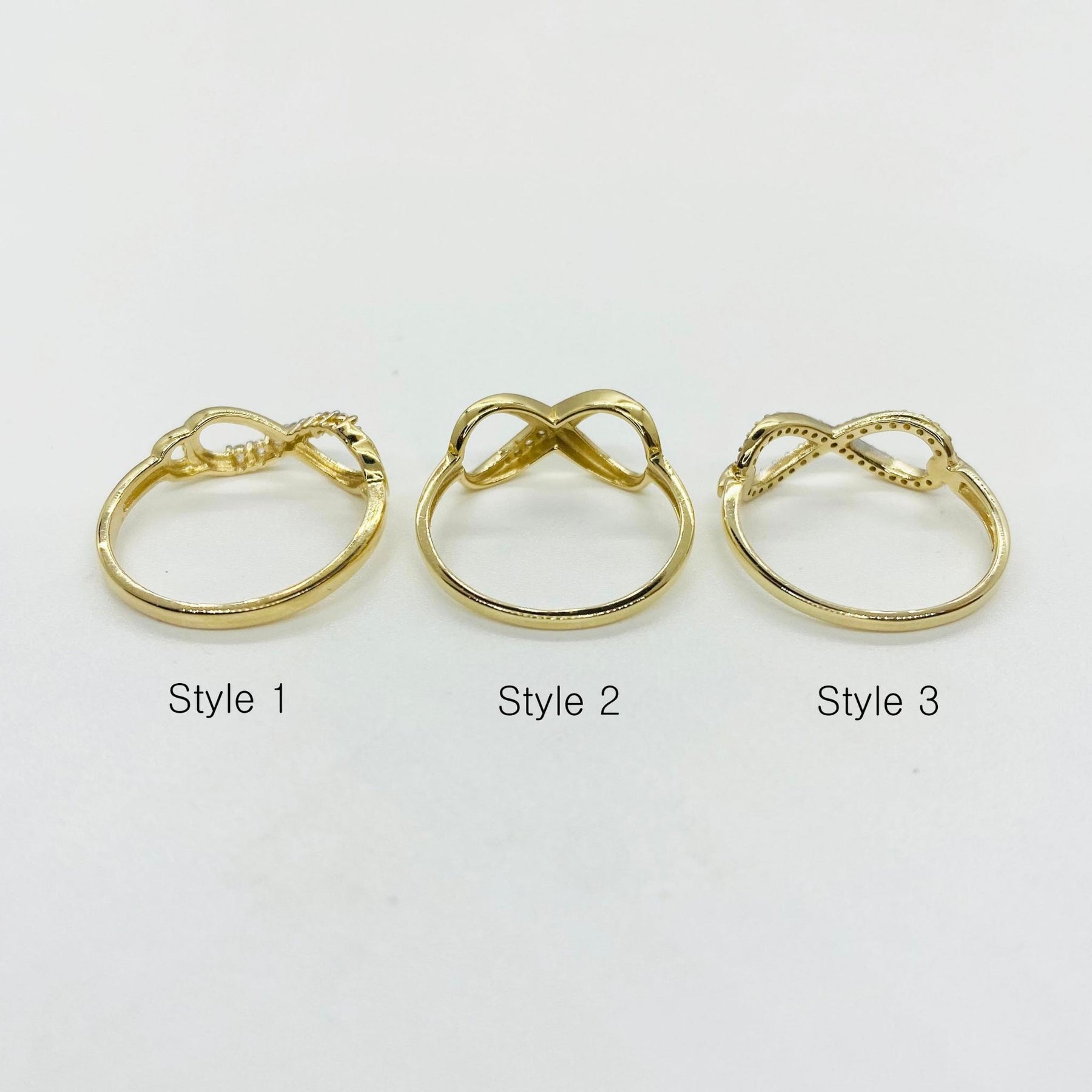 Three 14k gold infinity rings backview labeled Style 1, Style 2, and Style 3 
