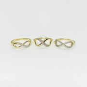 Three 14k gold infinity rings with Cubic Zirconia accents on a light gray background