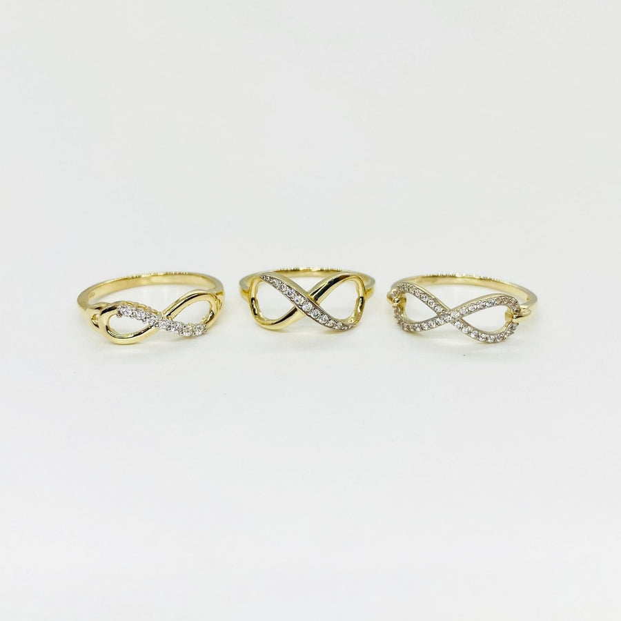 Three 14k gold infinity rings with Cubic Zirconia accents on a light gray background