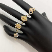 Set of 14k gold rings with Virgin Mary  designs on a black mannequin hand.