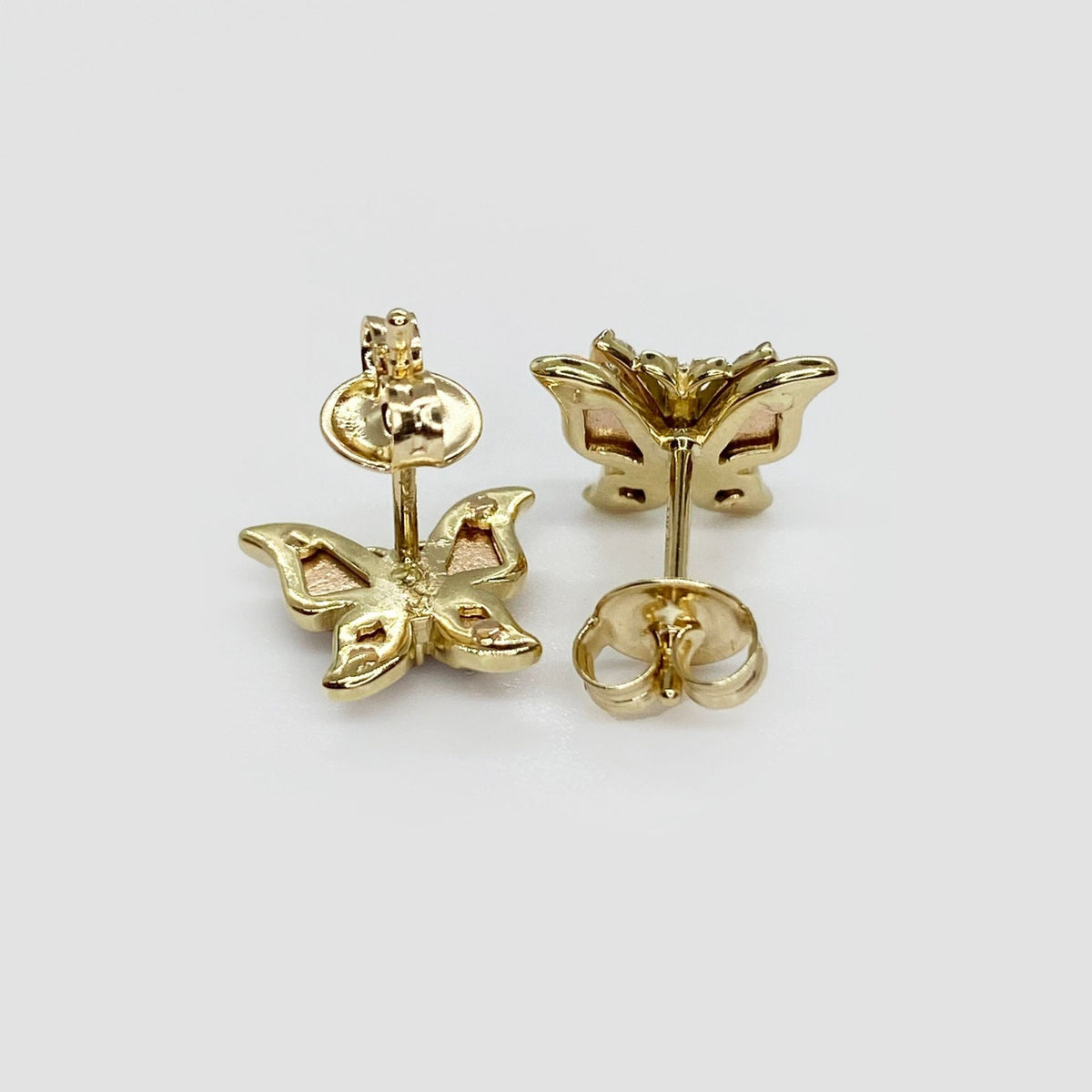 14k gold Aura butterfly stud earrings back view showing hollow filigree design and secure push-back closures.