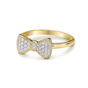 Close-up angled view of a 14k gold bow ring paved with cubic zirconia.