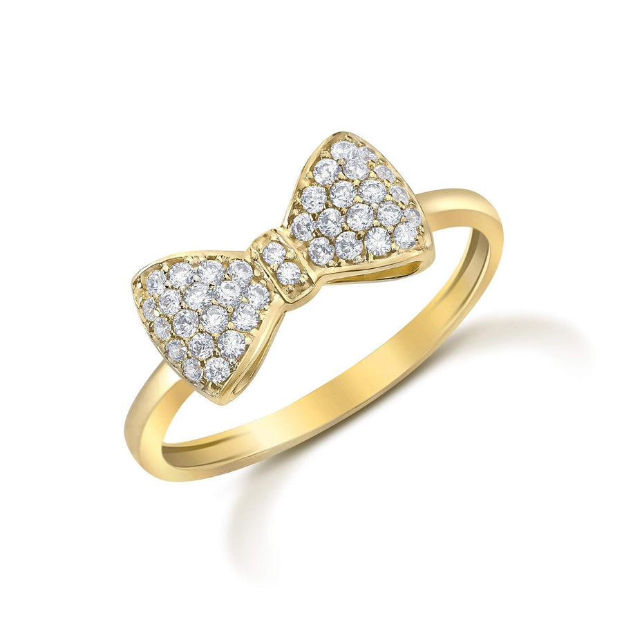Angled view of a 14k yellow gold bow-shaped ring paved with cubic zirconia stones.
