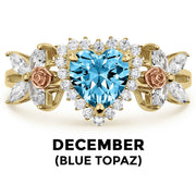 14k gold heart ring with blue topaz birthstone and December text label