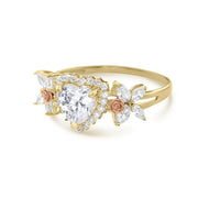 14k gold birthstone ring with a halo-set heart cz and rose gold flower details.