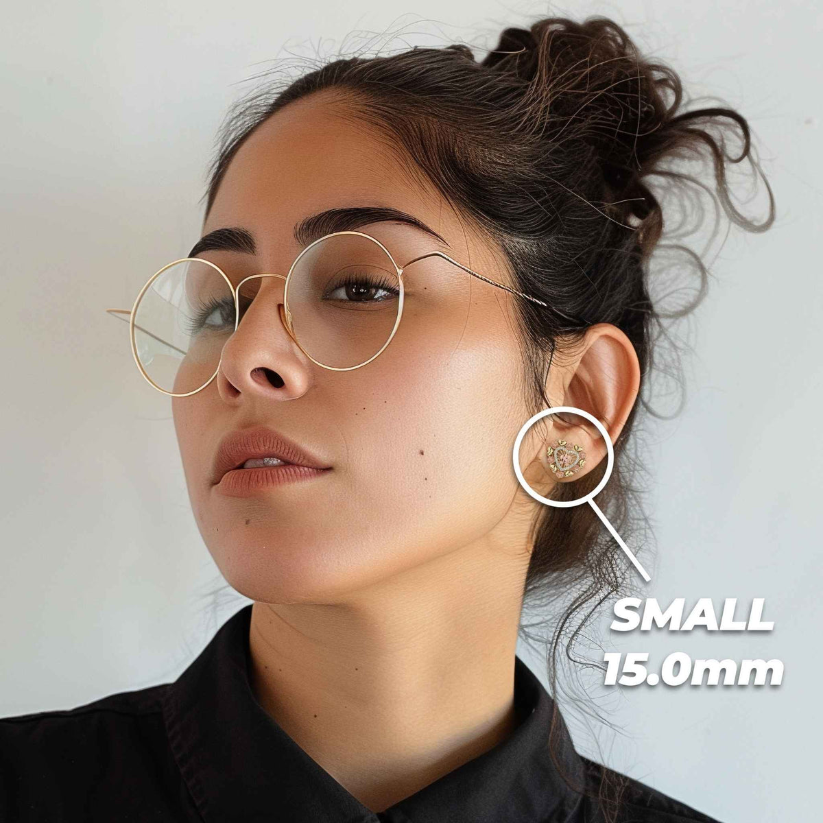 Woman wearing the small 15mm 14k tricolor gold elephant heart stud earring.