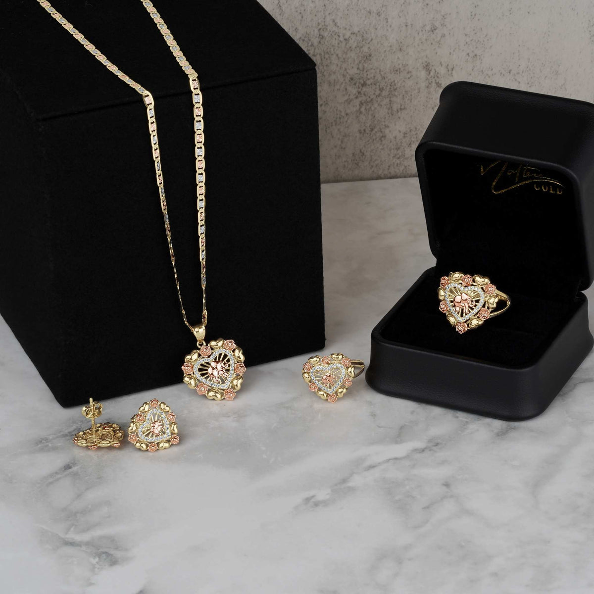 Collection of 14k tricolor gold elephant heart jewelry including earrings, pendant, and ring.