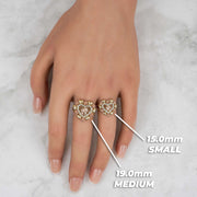 Hand wearing 19.0mm medium and 15.0mm small tricolor gold elephant heart rings.