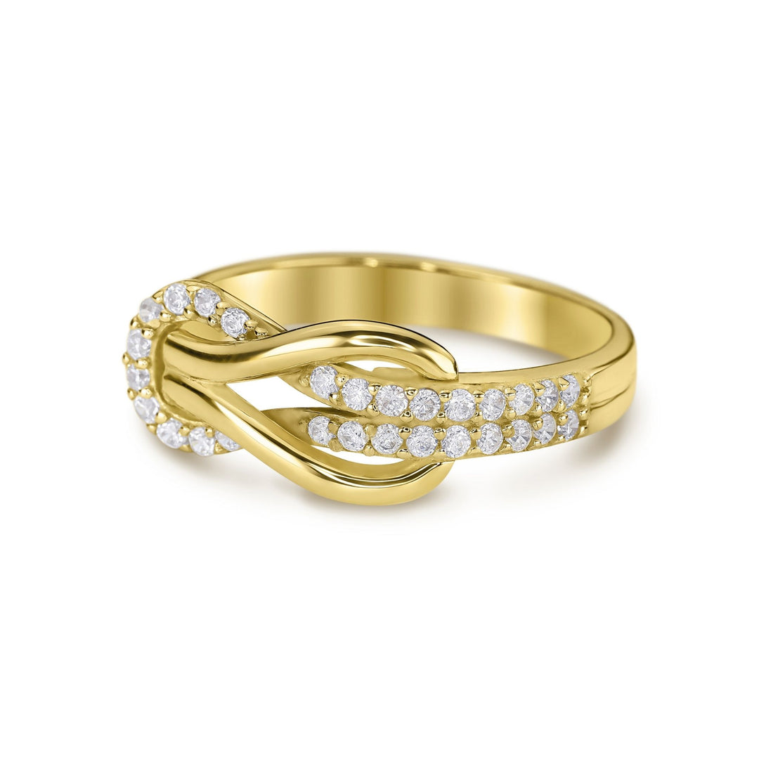 Close-up of a 14k yellow gold buckle infinity band featuring micropavé cubic zirconia.