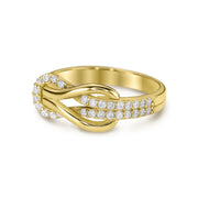 Close-up of a 14k yellow gold buckle infinity band featuring micropavé cubic zirconia.