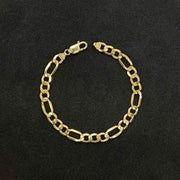 14k yellow gold classic Figaro link chain bracelet displayed on a textured black background.