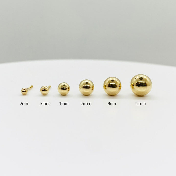Size guide for 14k yellow gold ball stud earrings, showing 2mm to 7mm options for scale.