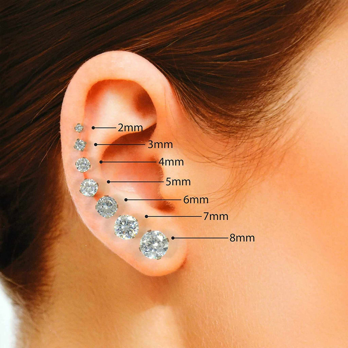 Size reference guide for 14k gold round CZ stud earrings, showing relative sizing from 2mm to 8mm on an earlobe.
