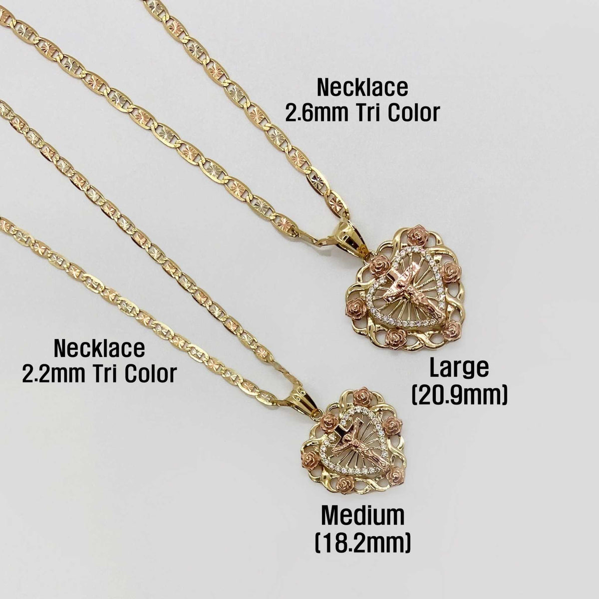 Medium and Large gold crucifix heart pendants shown on 2.2mm and 2.6mm tricolor chains.