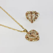 14k gold crucifix heart pendant necklace shown alongside a matching gold ring.