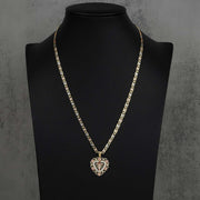 14k gold crucifix bloom rose heart pendant styled on a tricolor chain over a black mannequin bust.