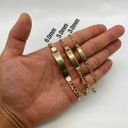 Person holding three 14k gold Cuban link ID chain bracelets in 3.0mm, 5.0mm, and 6.0mm widths.